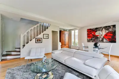a living room with a white couch and a staircase at Vbilla 5 stars in Tamaris