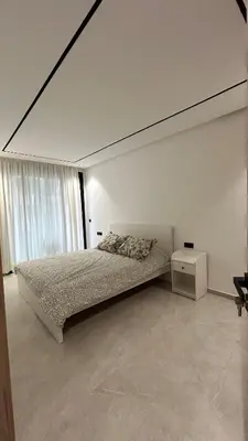 a bedroom with a bed and a large window at Central Casablanca Cozy Home in Casablanca