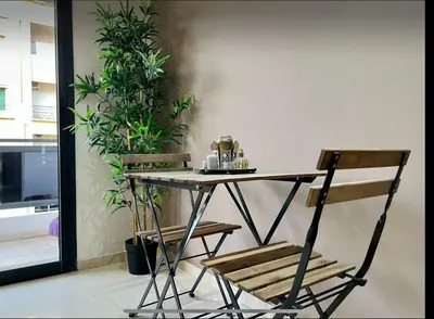 a table and two chairs in a room with plants at Anfa City in Casablanca