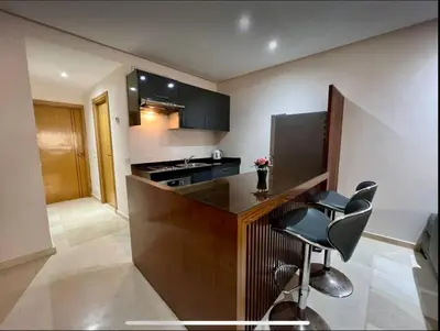 a kitchen with a counter and some chairs in it at Anfa City in Casablanca