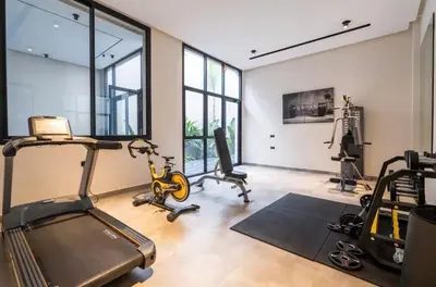 a gym with several exercise equipment in a room with windows at Chic Studio I Anfa Park & CFC I Gym Wifi & Parking in Casablanca