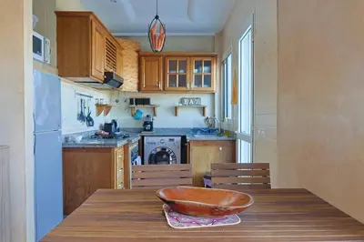 a kitchen with a wooden table with a bowl on it at La Coralline Pied dans l'eau, Vue apaisante in Casablanca