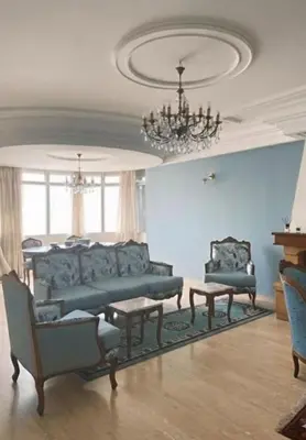 a living room with a couch and chairs and a chandelier at High Standing Apartment in Casablanca in Casablanca