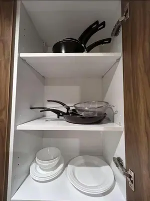 a kitchen shelf with plates and a pot and pans at MR9-03 Nice corner in the heart of Casa in Casablanca
