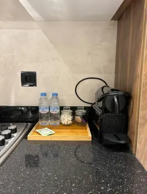 a table with bottles of water and a microwave at MR9-03 Nice corner in the heart of Casa in Casablanca