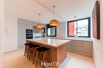 a kitchen with a large island with bar stools at Exceptional Private Room 1 SandRose in Casablanca