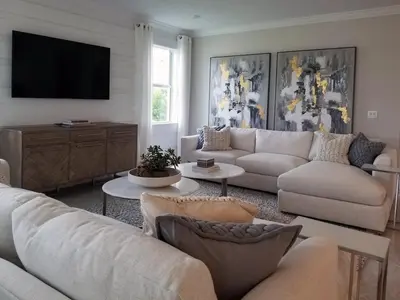 a living room with white furniture and a flat screen tv at Apparemment d été in Tamaris