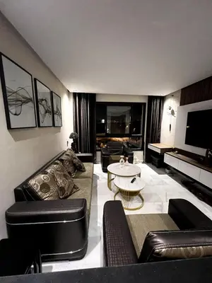 a living room with a couch and a table at Apartment - Casablanca - Palmiers in Casablanca