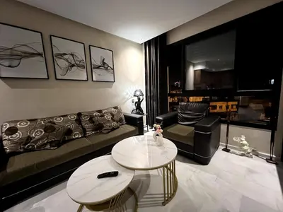 a living room with a couch and a table at Apartment - Casablanca - Palmiers in Casablanca