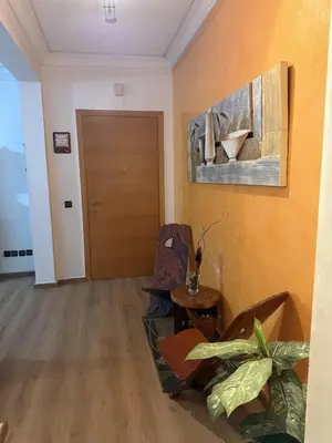 a living room with a table and chairs and a door at Comfortable apartment in Casablanca Assalam in Casablanca