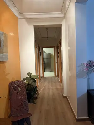 an empty hallway with a chair and a refrigerator at Comfortable apartment in Casablanca Assalam in Casablanca