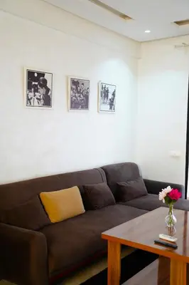 a living room with a brown couch and a table at Contemporary Moroccan elegance in the heart of Casa in Casablanca