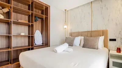 a bedroom with a large bed with wooden shelves at Dynasty Estate Luxury Apartments in Palmiers, Casablanca in Maarif