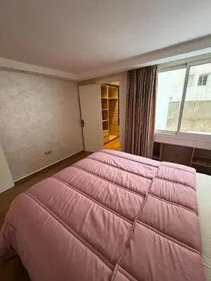 a large pink bed in a room with a window at Beautiful modern duplex - comfortable, good location in Casablanca