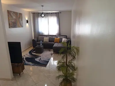 a living room with a couch and a tv at Téranga imm in Casablanca