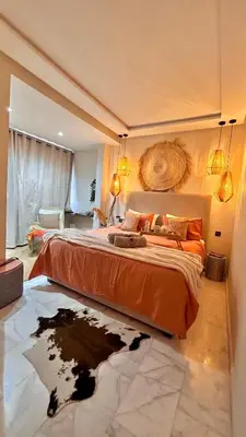 a bedroom with a large bed with a map on the floor at The Art of Staying in Casablanca