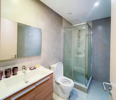 a bathroom with a toilet and a sink and a shower at Appartment 2 BR de luxe in Rabat