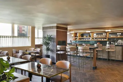 a restaurant with tables and chairs and a bar at DoubleTree By Hilton Casablanca City Centre in Casablanca