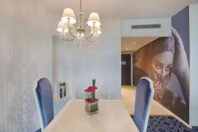 a dining room with a table and blue chairs at DoubleTree By Hilton Casablanca City Centre in Casablanca