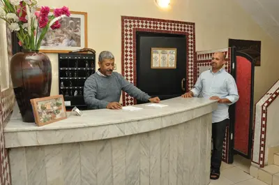 two men standing at a counter in a wine shop at Hotel Boustane in Casablanca