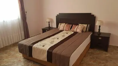 a bedroom with a large bed with two night stands at Zitouna Rooms in Casablanca