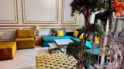 a living room with a couch and a table at Un Havre de paix a Ricoflores in Mohammedia