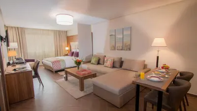 a living room with a couch and a bed at Melliber Appart Hotel in Casablanca