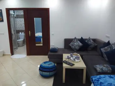 a living room with a couch and a table at Studios Taha in Rabat