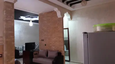 a living room with a couch and a refrigerator at Reem in Temara
