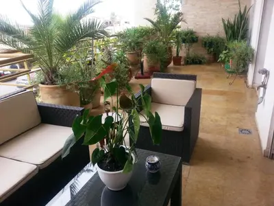 a living room filled with lots of potted plants at Perle de Tamaris in Dar Bouazza