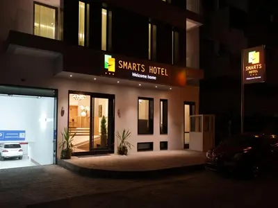 a smart hotel with a car parked in front of it at Smarts Hotel Agdal Rabat in Rabat
