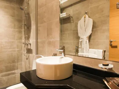 a bathroom with a white sink and a mirror at Smarts Hotel Agdal Rabat in Rabat