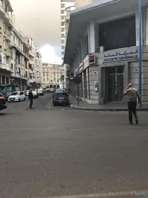 a man standing in the middle of a city street at Casablanca centre ville in Casablanca