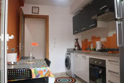 a kitchen with a table and a washing machine at Appartement ,Tram Parking and wifi gratui in Casablanca