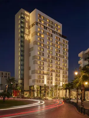 a tall white building with a road in front of it at The View Rabat in Rabat