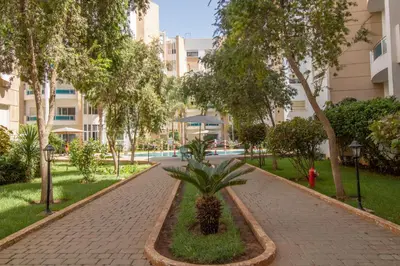 a brick walkway with a palm tree in a park at Luxe & sérénité près de l Aireport Mohamed 5, votre Havre de Paix in Nouaseur