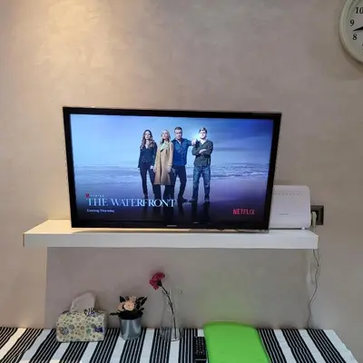 a flat screen tv sitting on top of a shelf at Cozy Studio in Casablanca , 1 km from Casavoyageurs station , Free parking in Casablanca