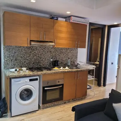 a kitchen with a washer and a washing machine at Cozy Studio in Casablanca , 1 km from Casavoyageurs station , Free parking in Casablanca