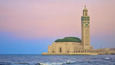 a building with a clock tower in the middle of the ocean at Cozy Studio in Casablanca , 1 km from Casavoyageurs station , Free parking in Casablanca