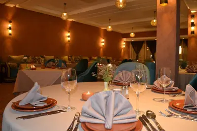 a table with wine glasses and napkins on it at Casablanca Le Lido Thalasso & Spa (ex Riad Salam) in Casablanca