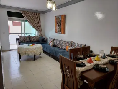 a living room with a couch and a table at Apartment in the city center, 2 minutes walk from the tram in Rabat