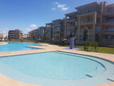a large swimming pool in front of a building at Evasion Bouznika أمام شاطىء بوزنيقة in Bouznika