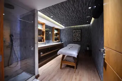 a small bathroom with a bench and a shower at Ocean Park Hotel, Premium Suites & Wellness in Casablanca