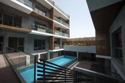 an external view of a building with a swimming pool at Ocean Park Hotel, Premium Suites & Wellness in Casablanca