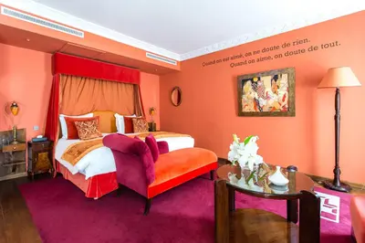 a hotel room with a bed and a chair at Hôtel particulier Le DOGE - Relais & Châteaux in Casablanca