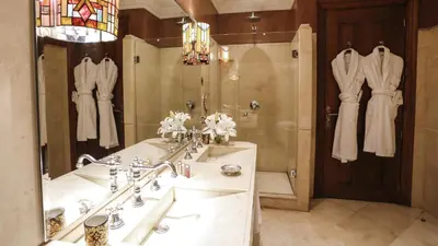 a bathroom with a sink and a shower and a mirror at Hôtel particulier Le DOGE - Relais & Châteaux in Casablanca