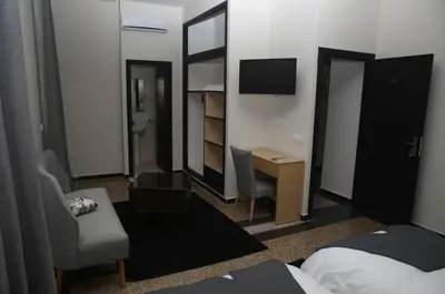 a hotel room with a bed and a desk and a television at Point du Jour in Casablanca