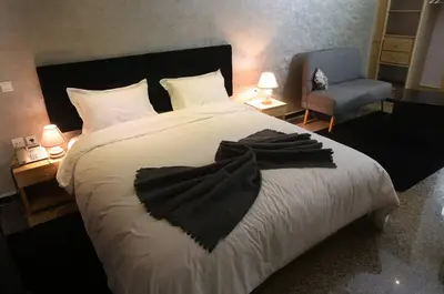 a bedroom with a bed with a black robe on it at Point du Jour in Casablanca