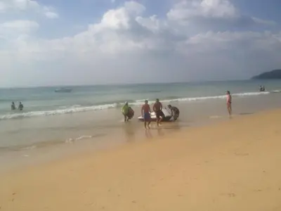 a group of people walking on the beach at Garden Beach Sidi Rahal in Sidi Rahal