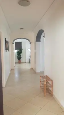 an empty hallway with a bench in the middle of a room at Garden Beach Sidi Rahal in Sidi Rahal